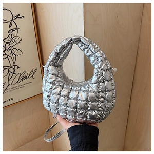 Detailed view of silver metallic quilted crescent bag with refined diamond stitching texture