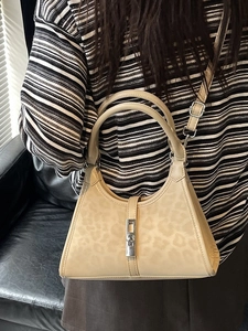 Elegant beige leopard print bucket bag with silver clasp for stylish women