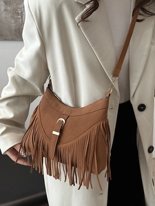 Retro brown suede shoulder bag with tassels and metal buckle for bohemian chic style