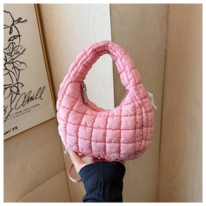 Detail of pink quilted puffy shoulder bag with metallic zipper and grid stitching