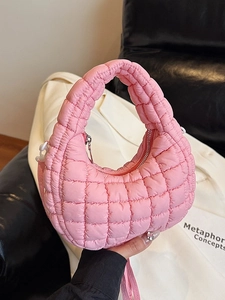 Pink quilted half-moon shoulder bag with puffy padding and a smooth zipper closure