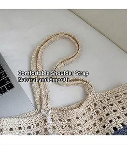 Close-up of beige crochet tote bag showing wide integrated shoulder strap and mesh weave