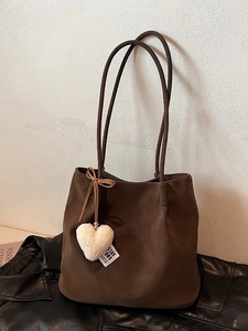 Retro dark brown matte tote bag with plush heart pendant on a soft textured background