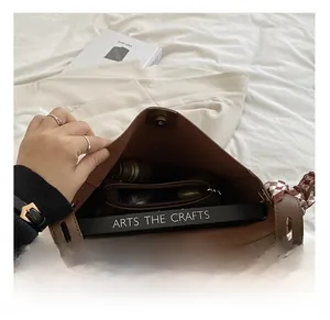 Interior view of large brown tote bag with zipper pocket and plaid silk scarf