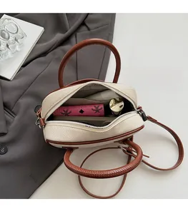 Internal view of a small Boston bag showing spacious storage for a phone and wallet
