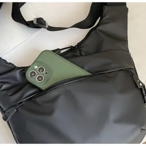 Close-up of the front zipper pocket showing large capacity for a smartphone