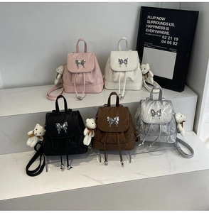 Detailed display of mini butterfly backpacks in pink, white, black, brown and silver colors