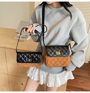 Detail of color-block quilted shoulder bag featuring gold twist lock and retro style