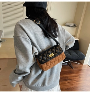 Detail of color-block quilted shoulder bag featuring brown suede and black leather flap