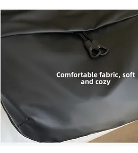 Detail shot of matte black crossbody bag showing soft waterproof fabric and dual zippers