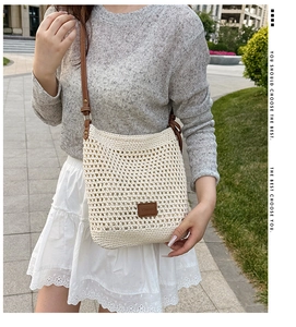 Detailed knit mesh weave on beige tote bag with a brown leather logo patch