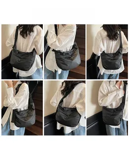 Detail shots of black nylon crossbody bag with dual zippers and adjustable wide strap