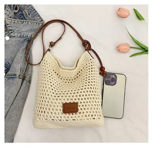Detail of crochet weave texture with leather logo and brown beaded shoulder strap