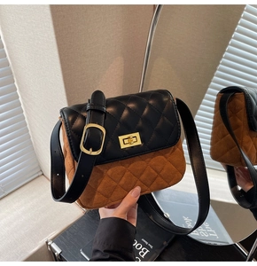 Detail of a vintage quilted shoulder bag with gold twist lock and brown suede contrast