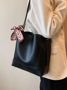 Classic black leather bucket tote bag for women with decorative plaid scarf accessory