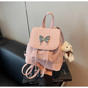 Detail of pink PU leather backpack with liquid silver butterfly and bear charm
