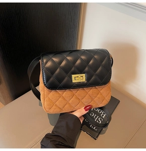 Detail of color-block bag showing quilted leather and suede texture with gold twist lock