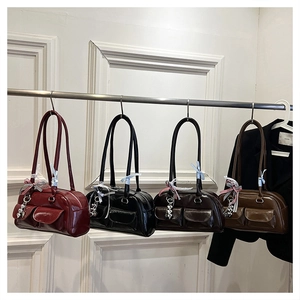 Detail view of retro bowling bags in various leather colors with bow and heart charms