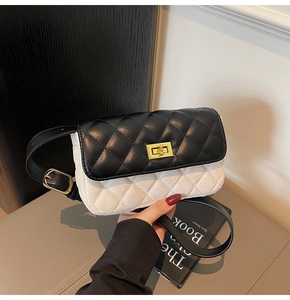 Detailed close-up of monochrome quilted bag with gold twist-lock and contrast stitching