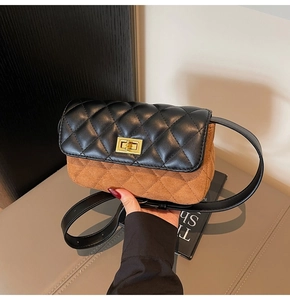 Detail of vintage rhombic stitching on two-tone leather and suede crossbody handbag