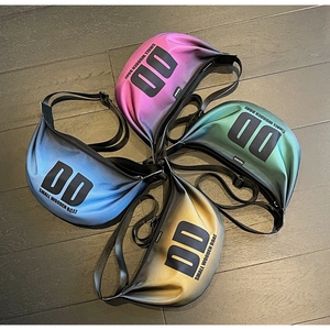Detail view of colorful nylon crossbody bags with letter prints and adjustable straps