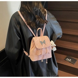 Pink pleated leather mini backpack featuring a butterfly metal buckle and bear charm