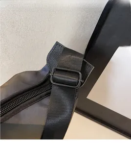 Detail of adjustable nylon strap with glossy black metal buckle and durable zipper