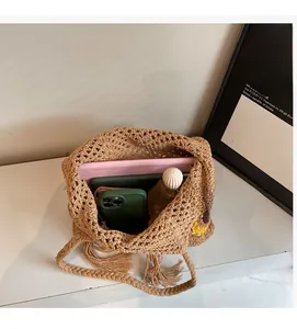 Detail of sunflower straw tote bag showing large capacity for tablet and phone