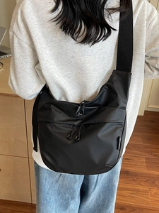 Black large capacity half-moon crossbody bag with wide strap shown from the back