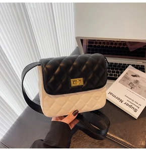 Close-up of contrast quilted crossbody bag featuring metal turn-lock and chain strap