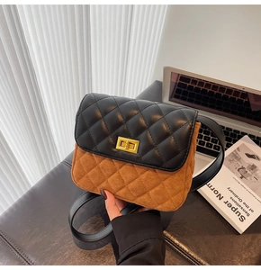 Detail of vintage square bag with two-tone patchwork and gold metal turn-lock closure