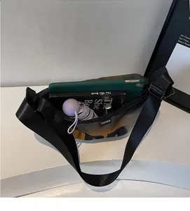 Macro shot showing internal capacity of the nylon crossbody bag with daily essentials