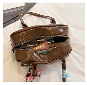 Macro view of spacious interior storage in brown leather vintage bowling handbag