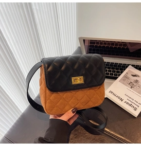 Detail of vintage crossbody bag with black quilted leather and brown suede textures