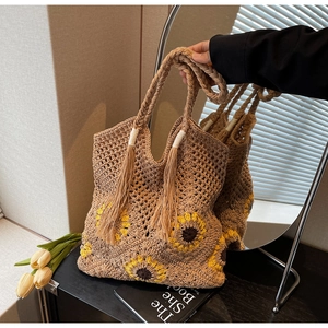 Close-up of handmade crochet sunflower tote bag with bohemian woven texture and tassels