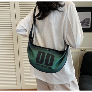 Rear view of model wearing a green gradient nylon crescent crossbody bag with DD logo