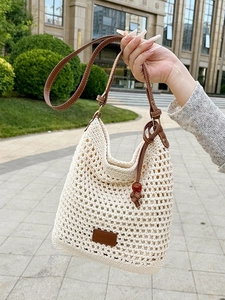 Handwoven cream crochet tote bag with brown leather straps for summer beach vacations