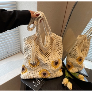 Detail of sunflower crochet tote bag featuring handcrafted weaving and tassel accents