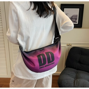 Detail view of purple-to-black gradient crescent bag with adjustable wide strap