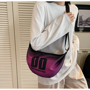 Detail of purple gradient nylon crescent bag with small wooden boat lettering