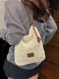 Chic beige woven hollow tote bag with brown leather shoulder straps for beach vacation