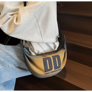 Detail of the yellow-black gradient nylon crescent bag with DD letter print branding