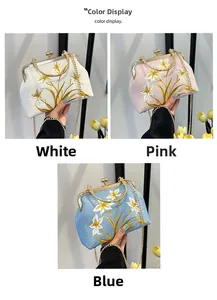 Detailed embroidery of lily flowers on elegant fabric clutch bags with golden metal chain