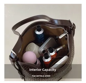 Internal view of woven leather bucket bag showing large capacity for essentials