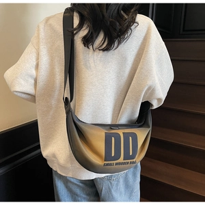 Fashionable gradient nylon crescent bag worn as a crossbody waist pack by a model