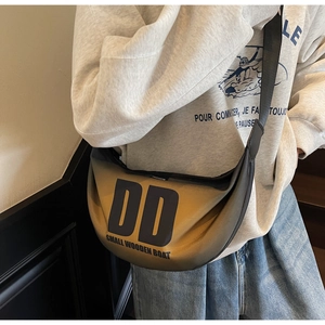 Detail of a gradient nylon crescent bag with letter print and black wide shoulder strap