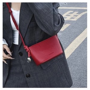 Red lychee grain leather crossbody bucket bag with fashion print and heart charm detail