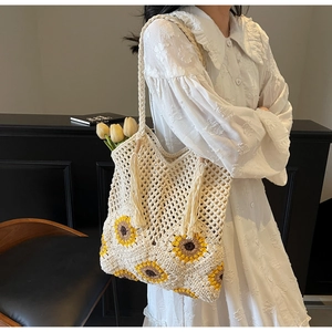 Detailed macro of handmade crochet sunflower tote bag with tassel and mesh texture
