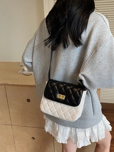 Vintage quilted crossbody bag with black leather flap and cream textured base