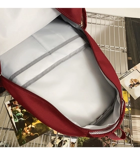 Detail of laptop compartment and multi-functional inner pockets in dark red backpack